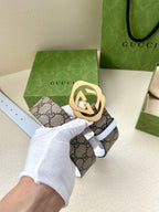 Gucci belt with GG monogram strap, gold interlocking buckle, white keeper strap