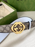 Gucci belt featuring GG monogram canvas and gold-tone Interlocking G buckle on white strap