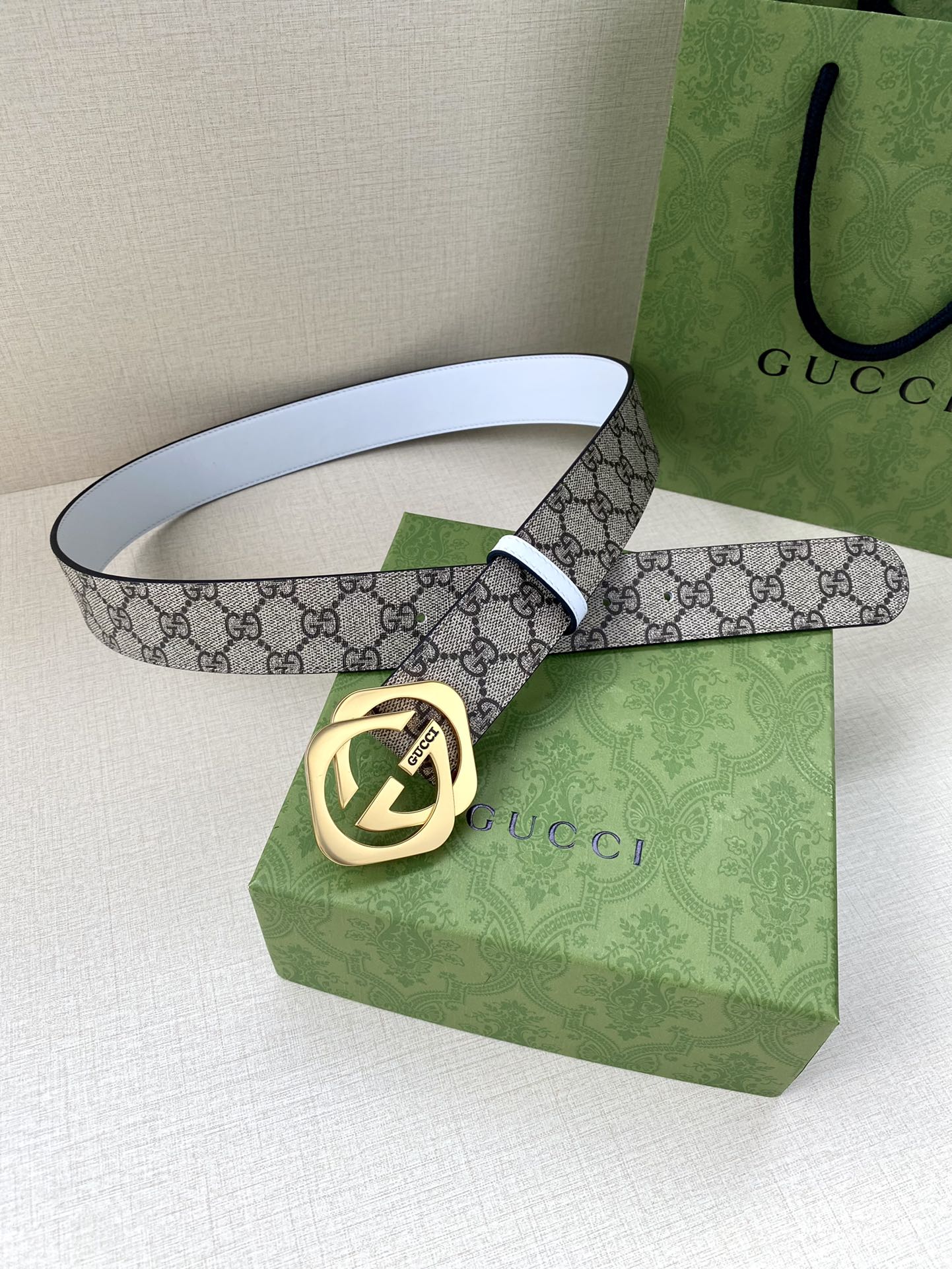 Gucci belt with GG monogram canvas strap and gold-tone Interlocking G buckle, white edging