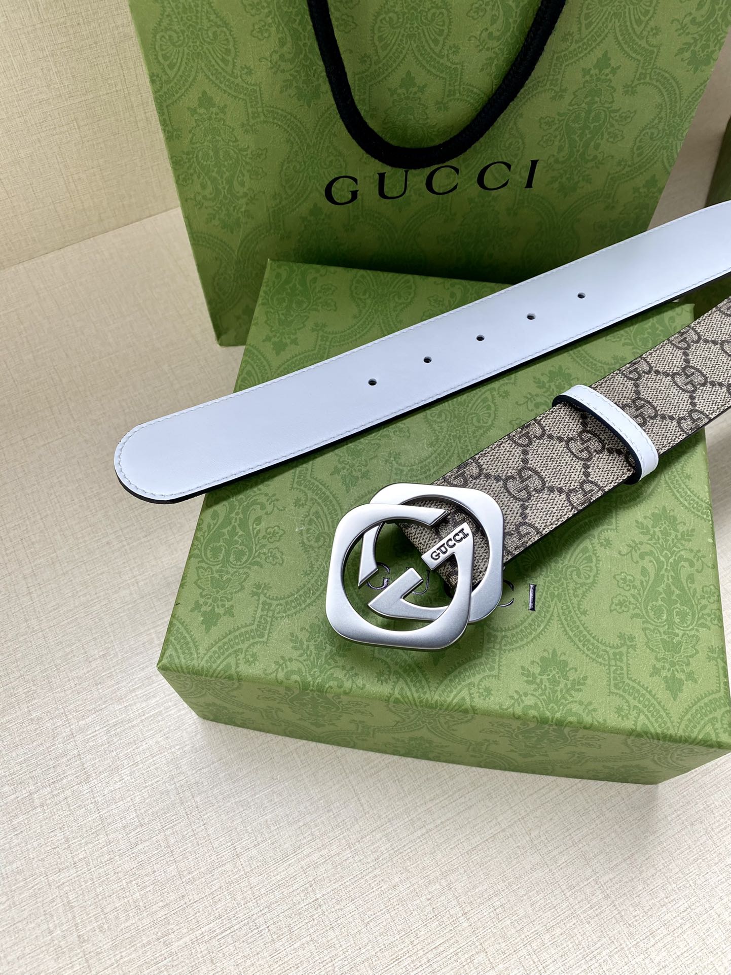 Gucci belt with white leather strap and GG monogram canvas, silver-tone Interlocking G buckle