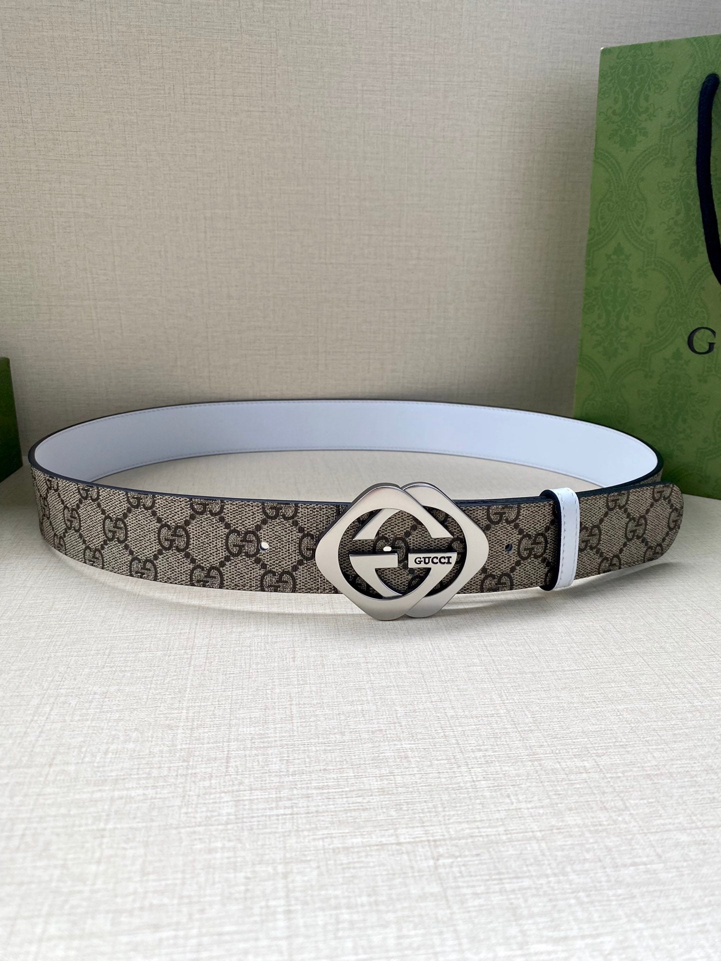 Gucci belt with GG monogram canvas and silver-tone Interlocking G buckle, white leather strap