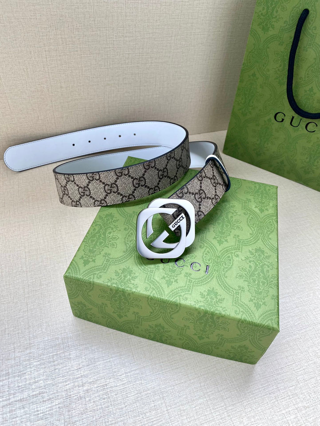 Gucci belt with GG monogram canvas, silver-tone Interlocking G buckle, white strap with holes