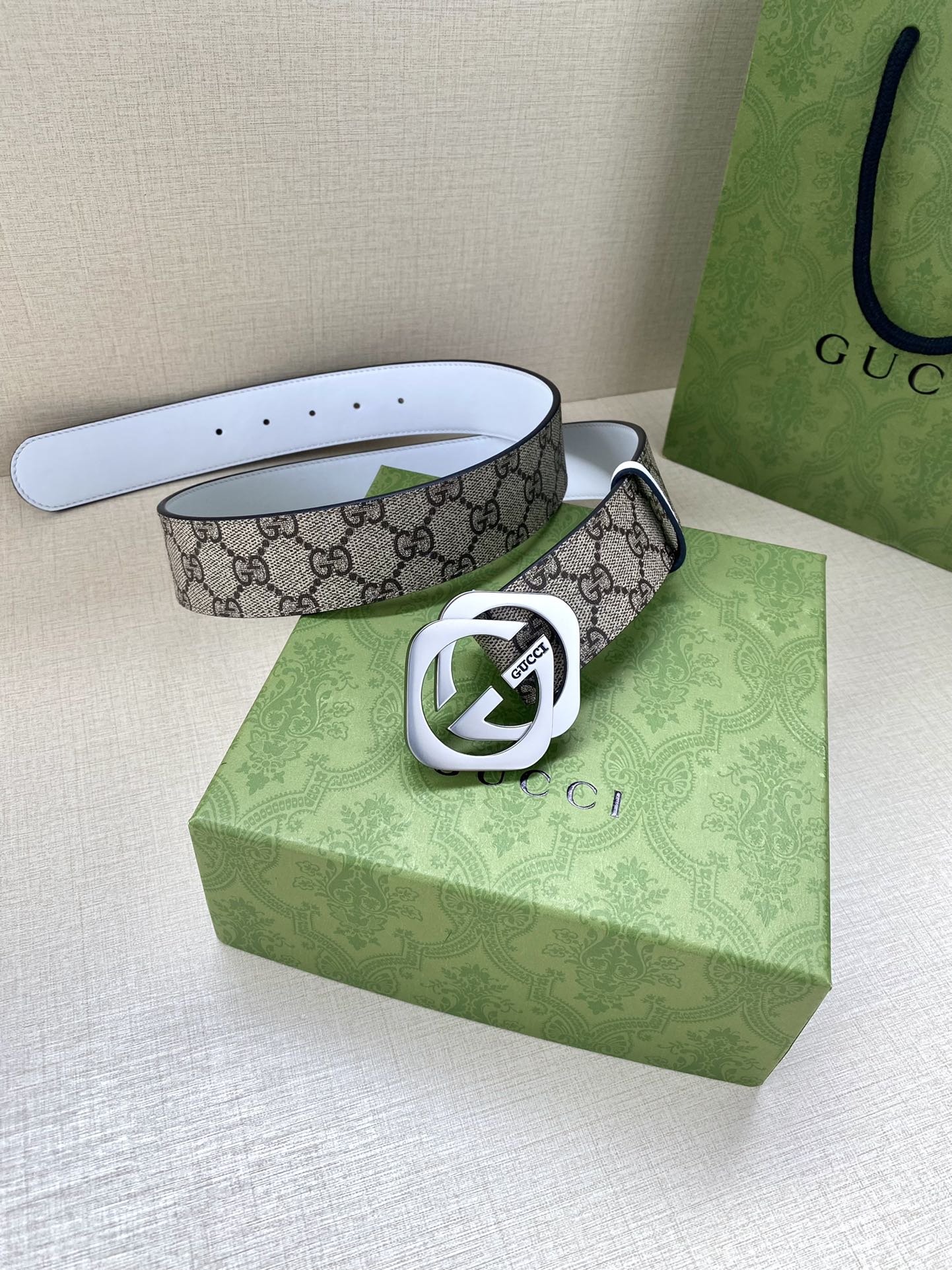 Gucci belt with GG monogram canvas, silver-tone Interlocking G buckle, white strap with holes