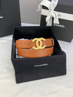 Tan leather belt with gold-tone CC buckle in a black gift box