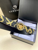 Navy patterned belt with gold medallion buckle on folded strap