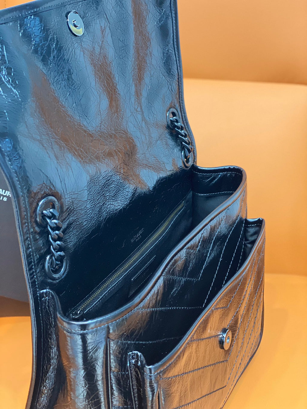 YSL Saint Laurent bag side view with chain straps and metal hardware on blue leather