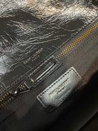 YSL Saint Laurent zipper pouch with embossed logo patch and metal pull on dark leather