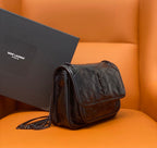 Saint Laurent quilted leather crossbody bag, side view, chain strap