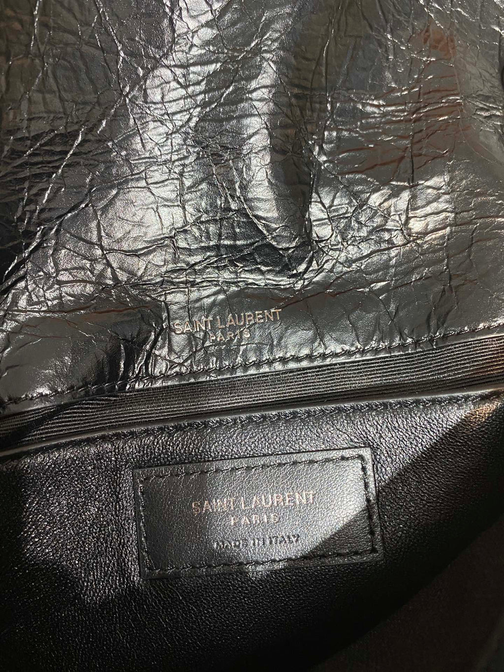 Saint Laurent leather bag interior logo patch on dark lining