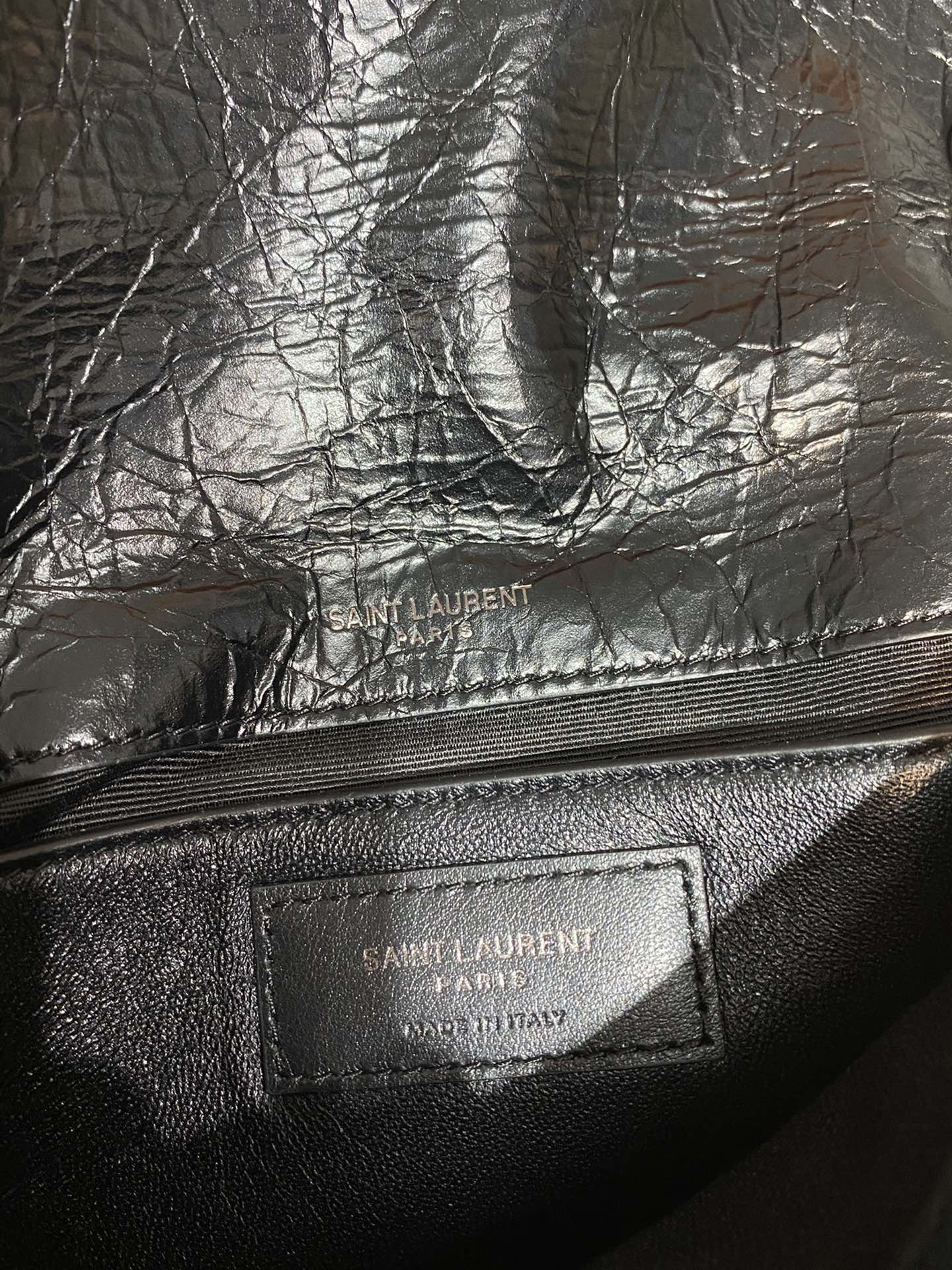 Saint Laurent leather bag interior logo patch on dark lining