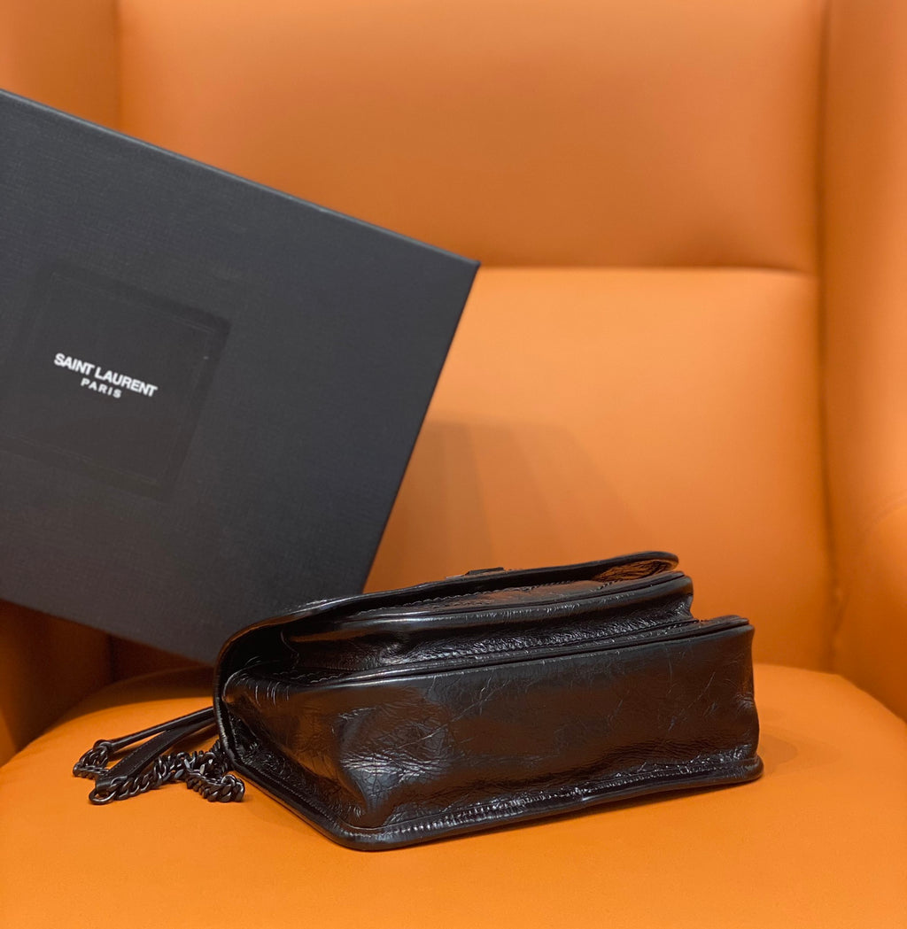 Saint Laurent leather crossbody bag with flap and chain strap, angled view