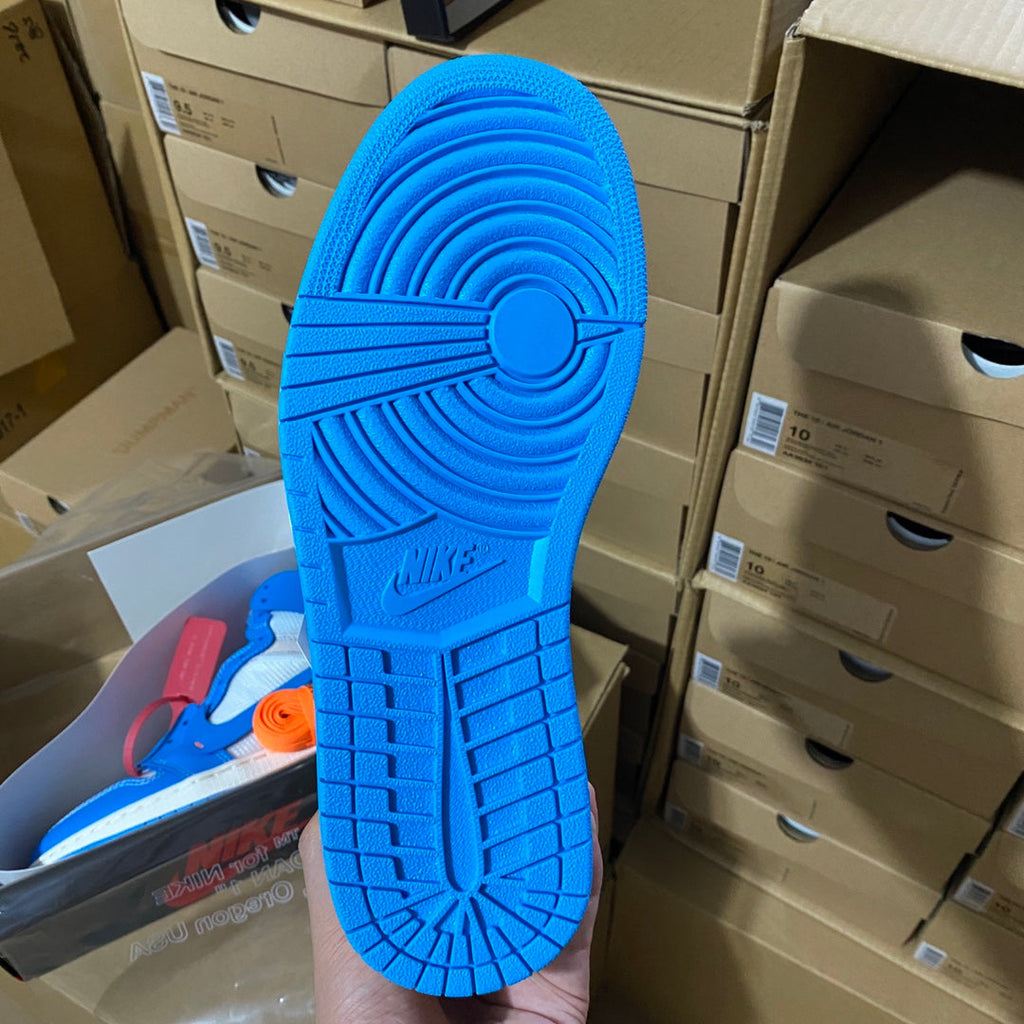 Blue rubber outsole with multidirectional tread pattern on a high-top sneaker.