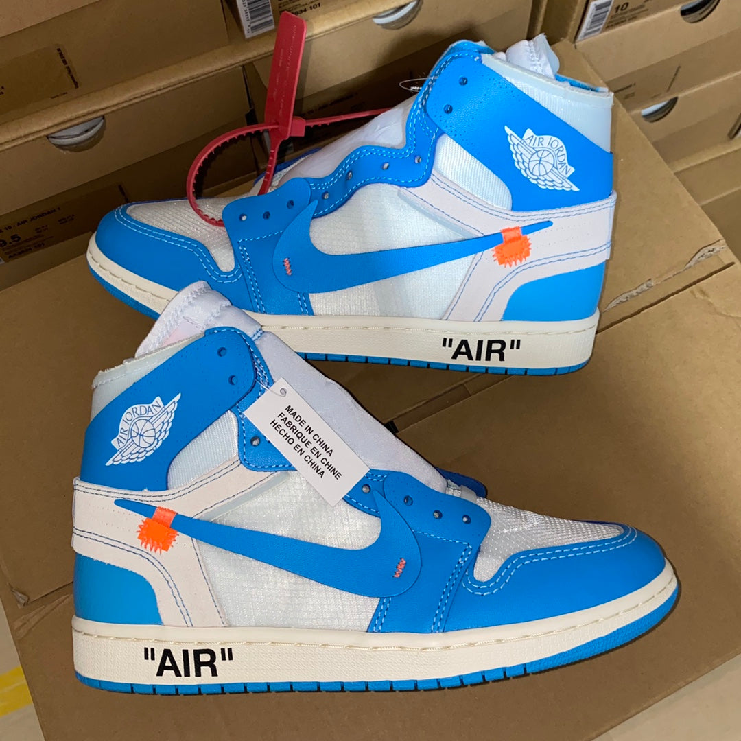 Pair of blue and white high-top sneakers with orange accent strap and Swoosh.