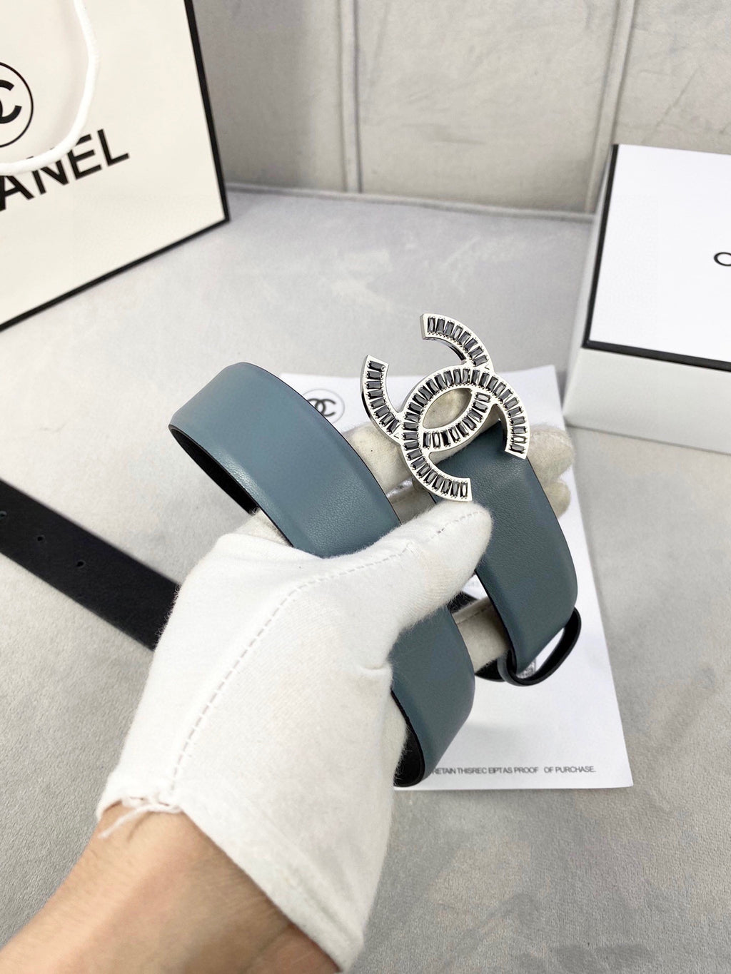 Chanel leather belt with muted blue strap and CC buckle on belt end