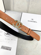 Chanel leather belt with tan strap and gold-tone CC buckle over black underside
