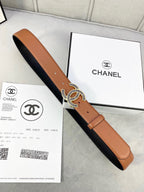 Chanel leather belt with tan front, black underside, and gold-tone interlocking CC buckle