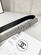 Chanel leather belt with gray strap and gold-tone CC logo buckle on display