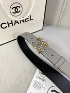 Chanel leather belt close-up with gray strap, black underside, and gold-tone CC buckle