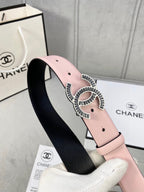 Chanel belt with pale pink leather strap and gold logo buckle over black interior lining