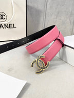 Chanel belt angled display with pink strap, silver CC buckle, and black underside.