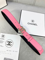 Chanel belt with pink leather strap and ornate CC buckle, shown with retail boxes.