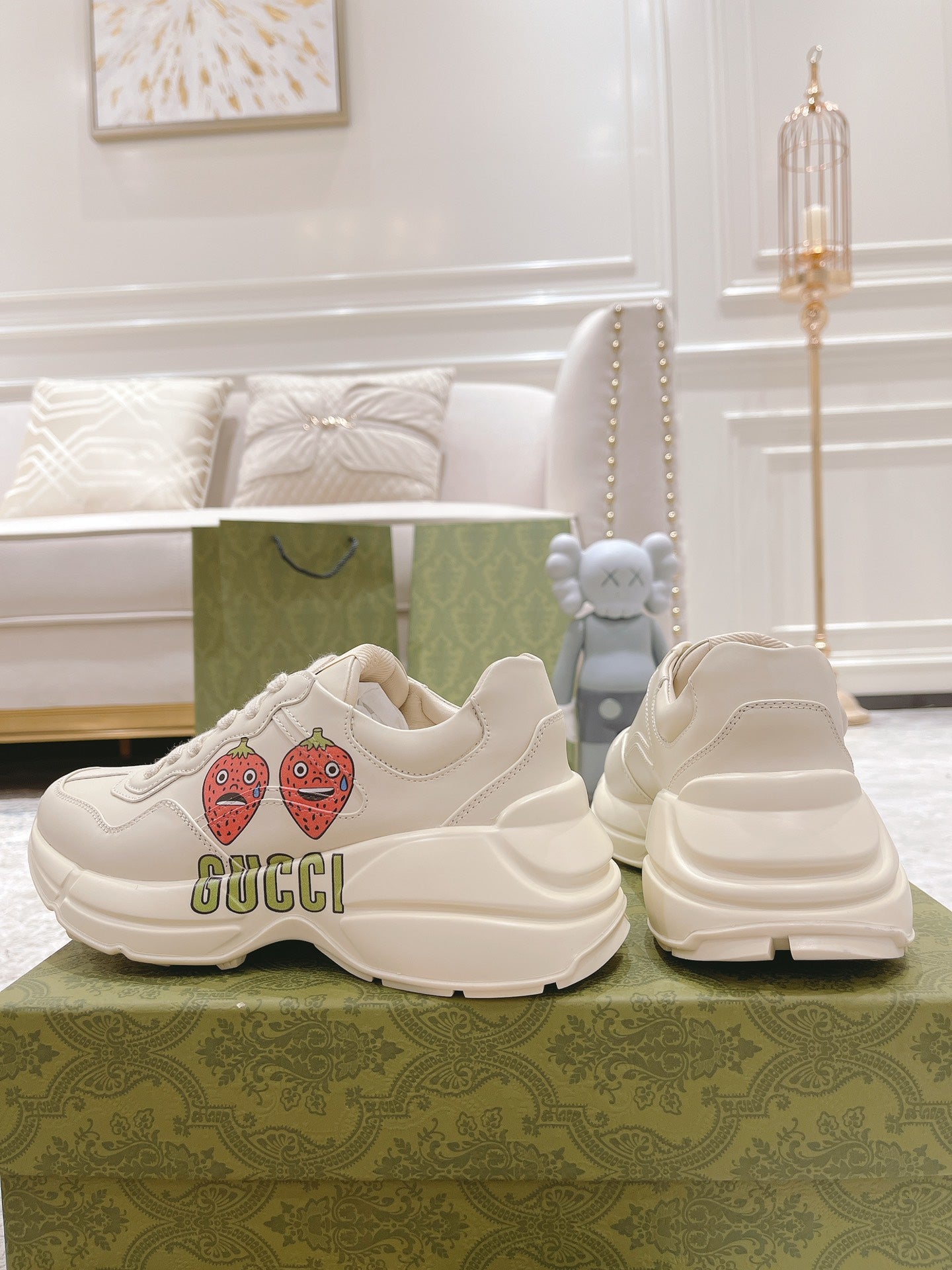 White lace-up sneakers set with strawberry patches and GUCCI logo, side and heel