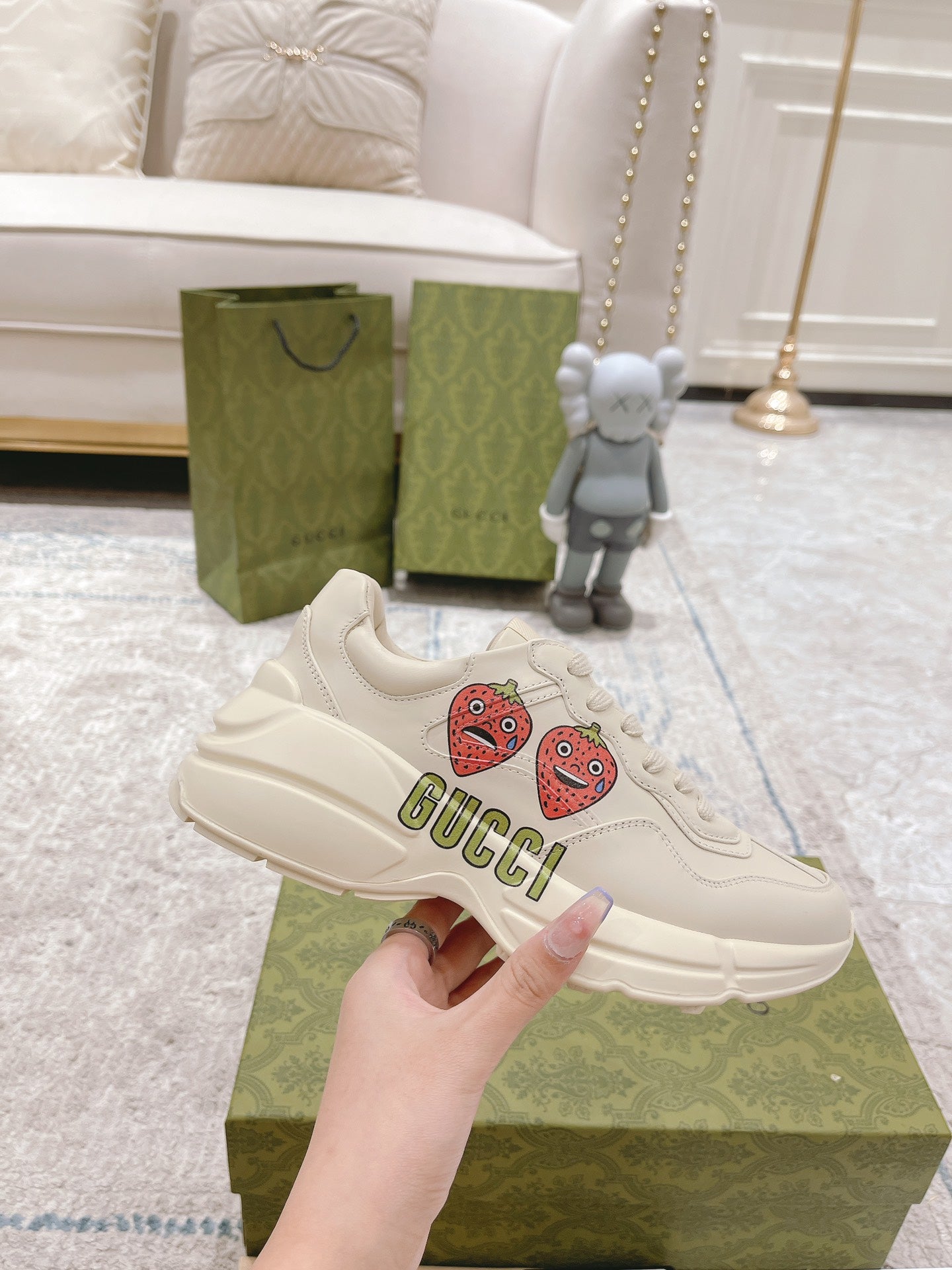White leather lace-up sneakers with strawberry patches and GUCCI logo on side