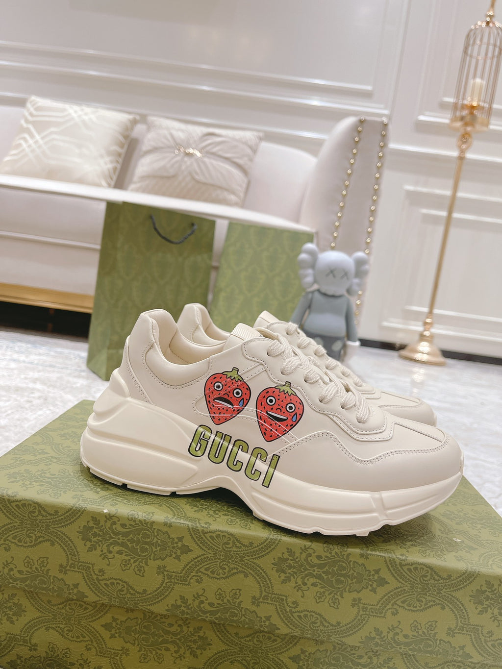 White leather lace-up sneakers with strawberry patches and GUCCI logo on side