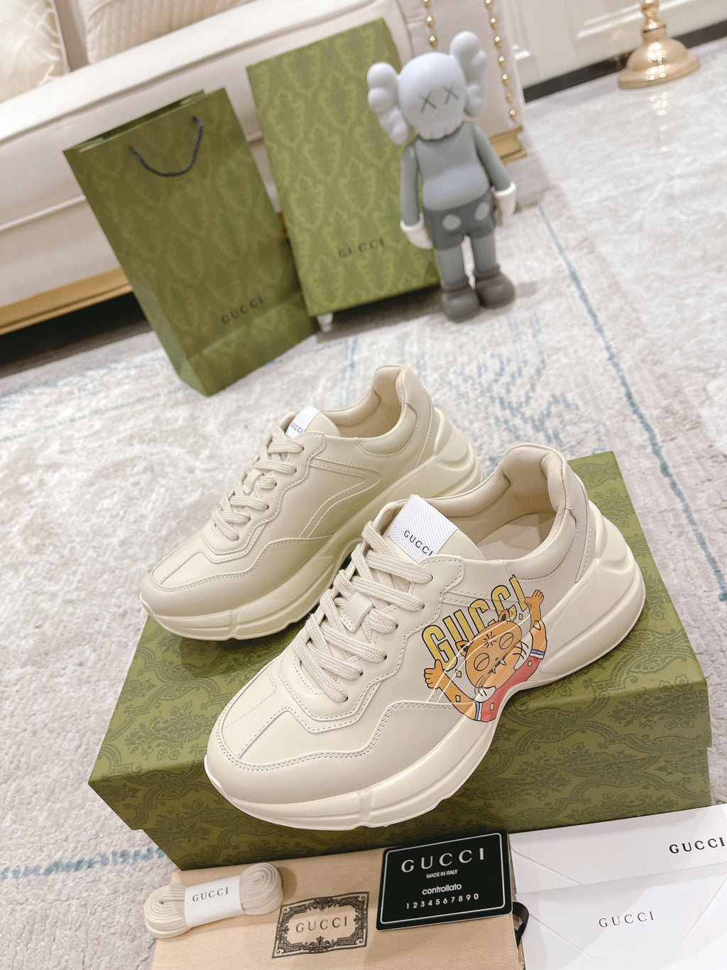 White Gucci lace-up sneakers with cartoon tongue graphic and thick sole