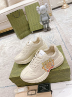 White Gucci lace-up sneakers with cartoon tongue graphic and thick sole