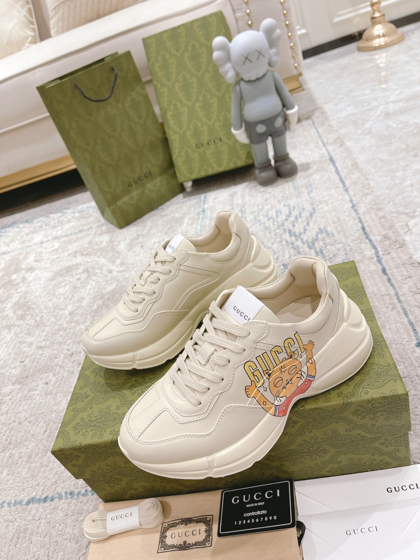 White Gucci lace-up sneakers with cartoon tongue graphic and thick sole