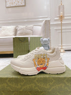 White Gucci sneakers with cartoon front graphic and low-profile sole