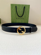 Navy leather belt with gold GG buckle on center, looped strap and perforations