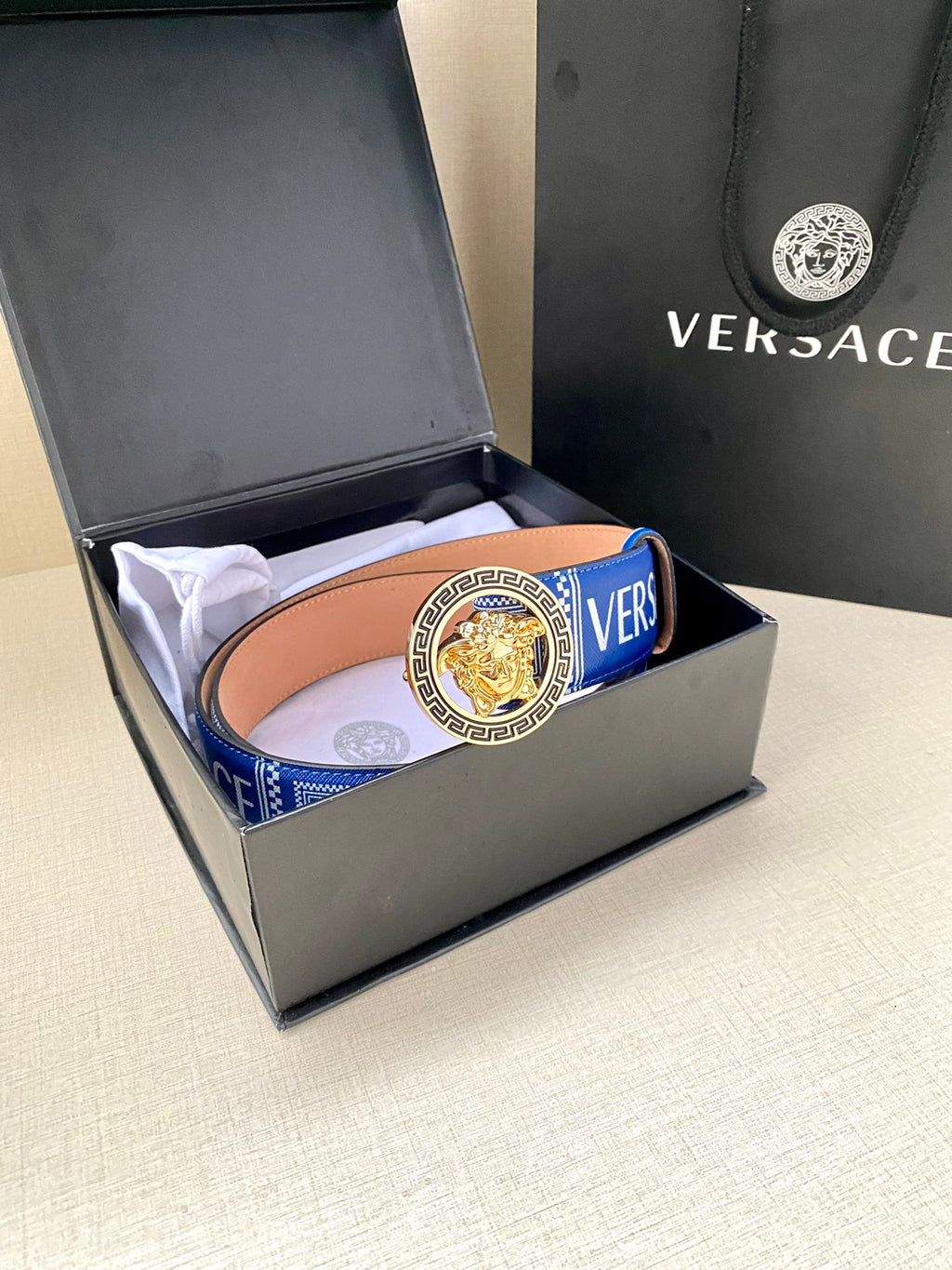 Versace belt in box: blue patterned strap with round gold medallion buckle