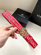 Versace belt with red patterned strap and circular gold lion buckle