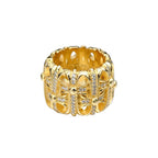 Gold-tone crystal-studded chrome ring with patterned band and raised center stones
