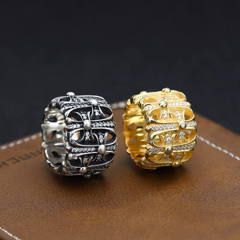 Two jeweled chrome rings: silver-tone and gold-tone with ornate stone setting