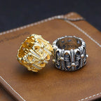 Gold-tone and silver-tone chrome rings with crystal-like stones on textured band