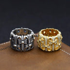 Silver-tone jeweled chrome ring with raised center stones and patterned band