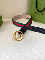 Gucci belt with navy strap and gold-toned circular buckle; green-red striped band