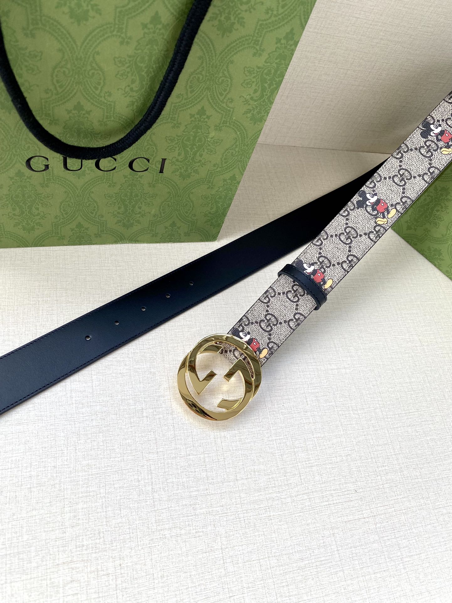 Gucci belt, navy leather strap with GG monogram Mickey print; gold-tone interlocking buckle