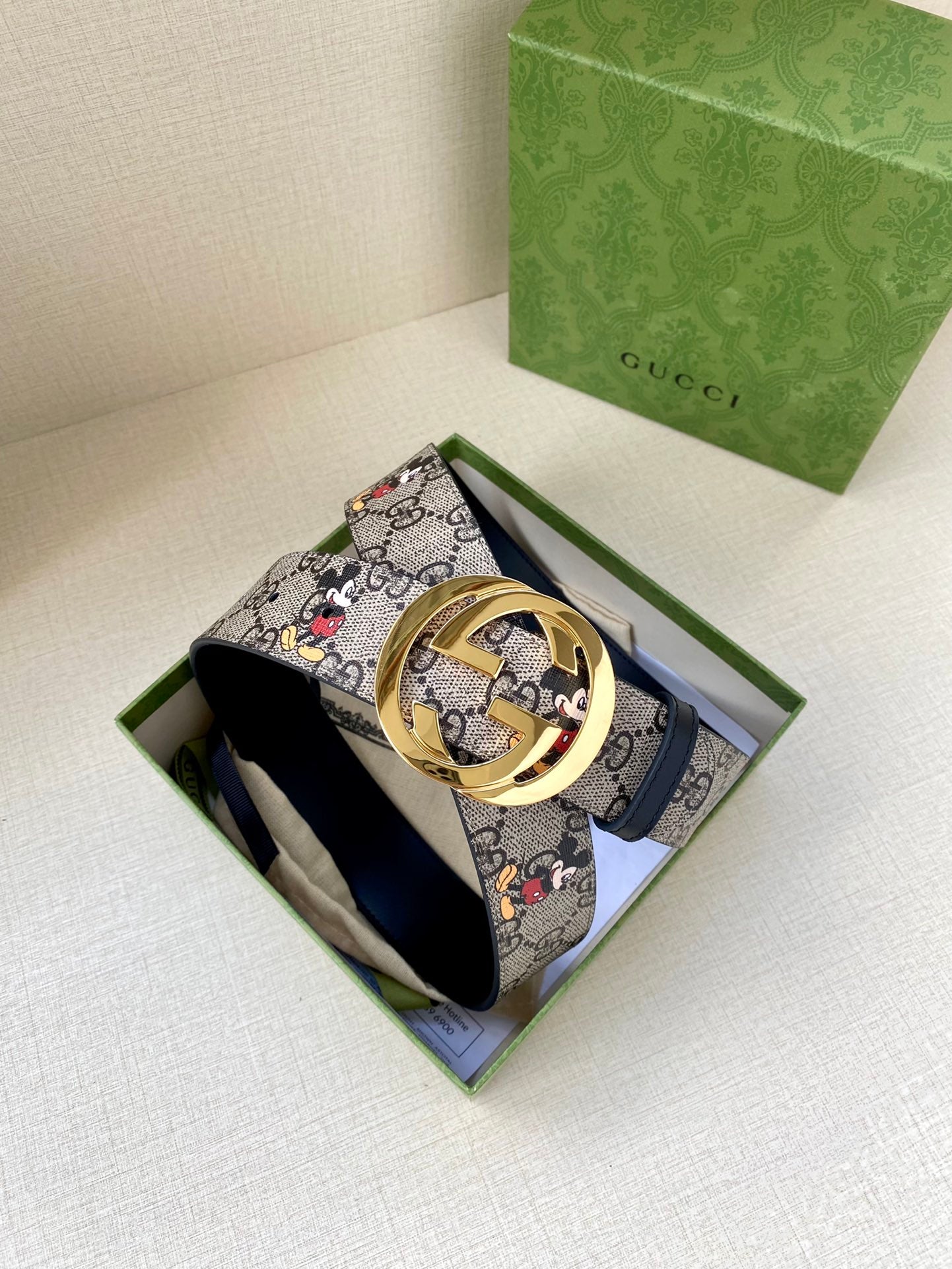 Gucci belt in navy GG monogram with Mickey print; gold-tone interlocking buckle