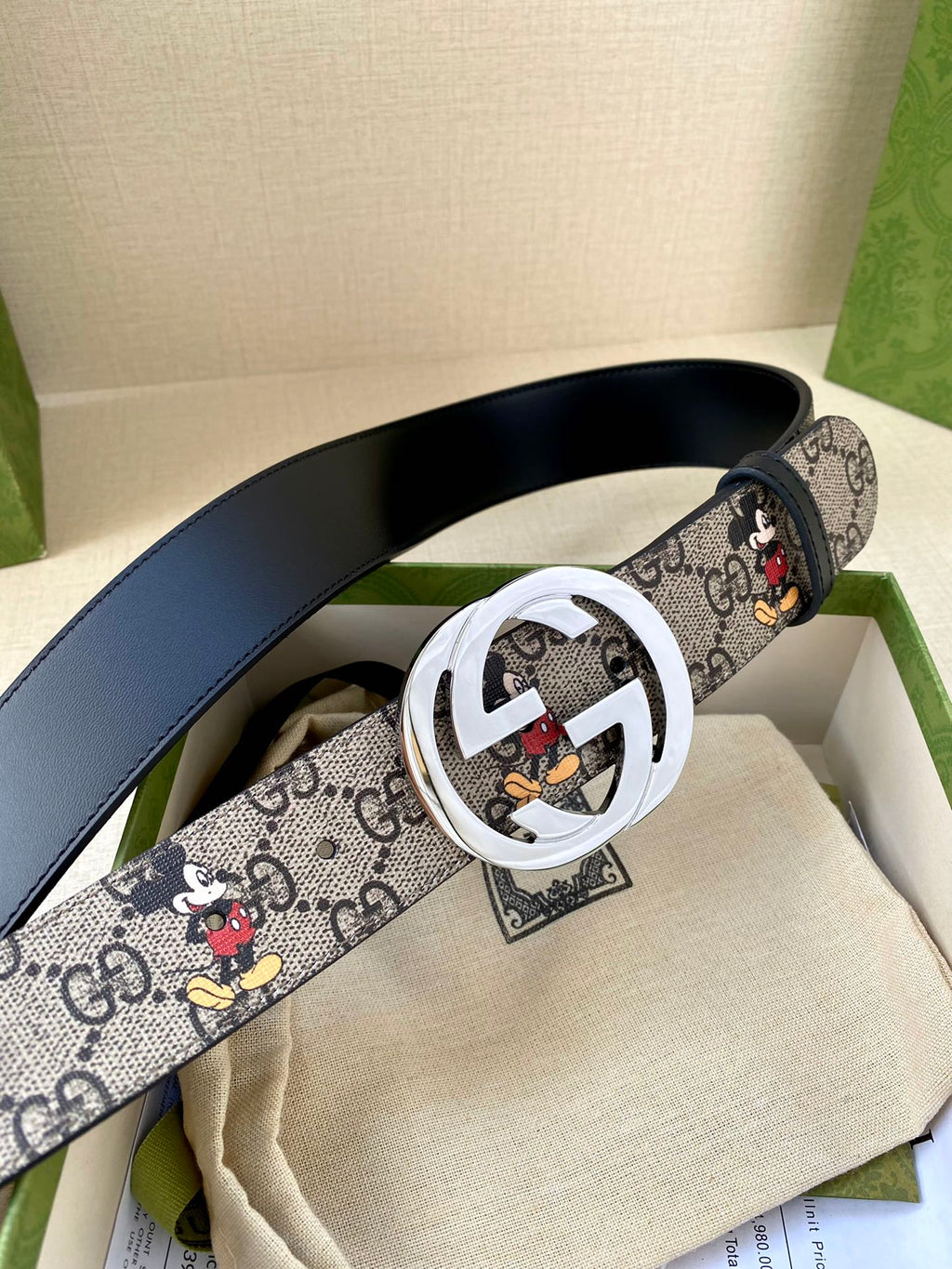 Gucci belt with navy GG monogram and Mickey print strap; silver interlocking G buckle