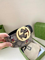 Gucci belt close-up, navy GG monogram with Mickey print; gold-tone interlocking buckle