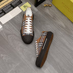 Pair of Burberry check sneakers with white laces and dark toe cap on gray flooring