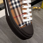 Burberry check-print sneaker close-up with white laces and dark rubber edging