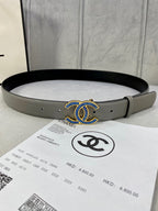 Chanel belt in light gray leather with blue-and-gold logo buckle at center