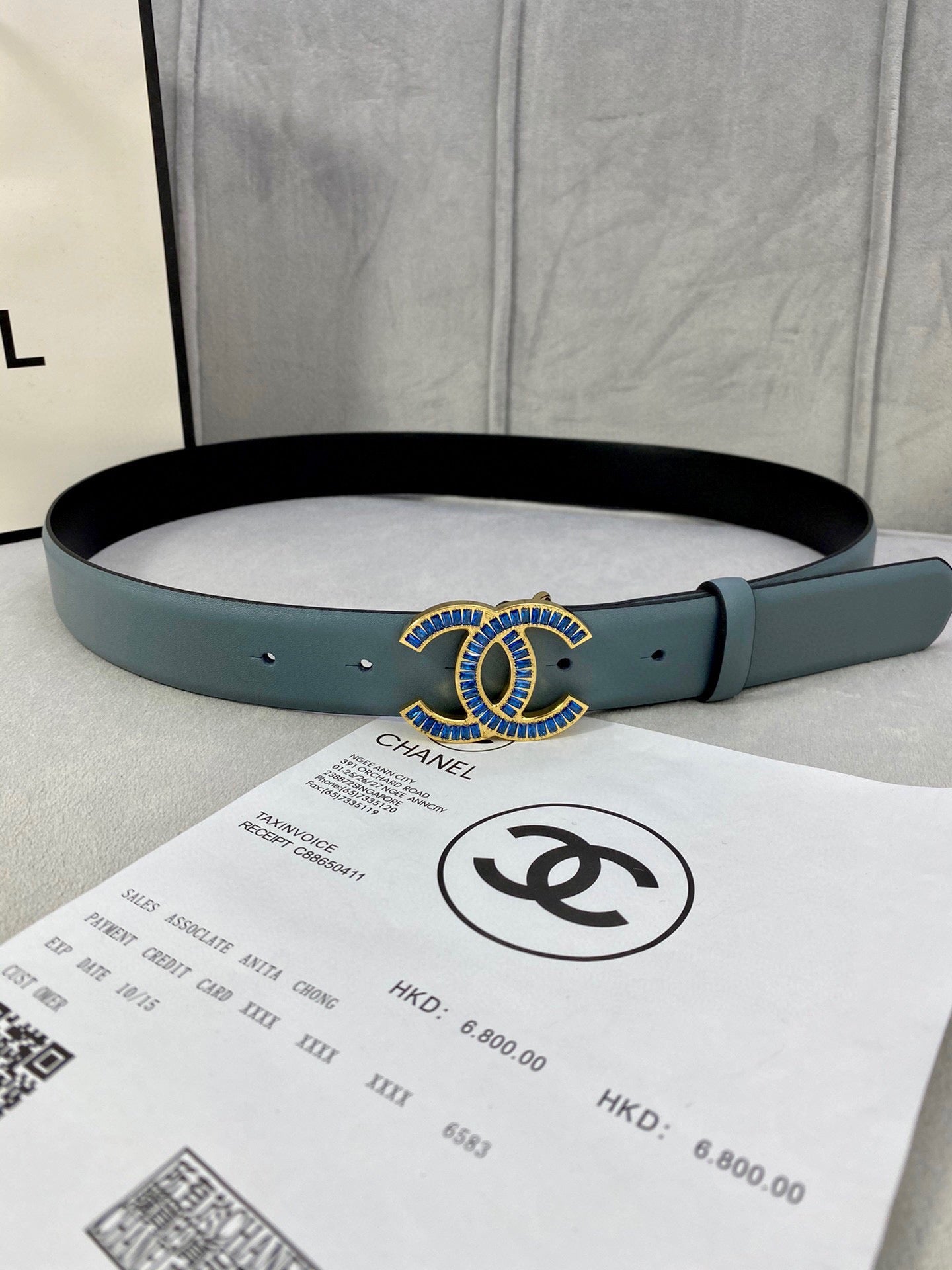 Light blue Chanel belt with gold and blue logo buckle and adjustable holes