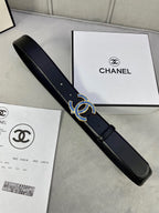 Black leather belt with blue CC-style embellished buckle, diagonal view