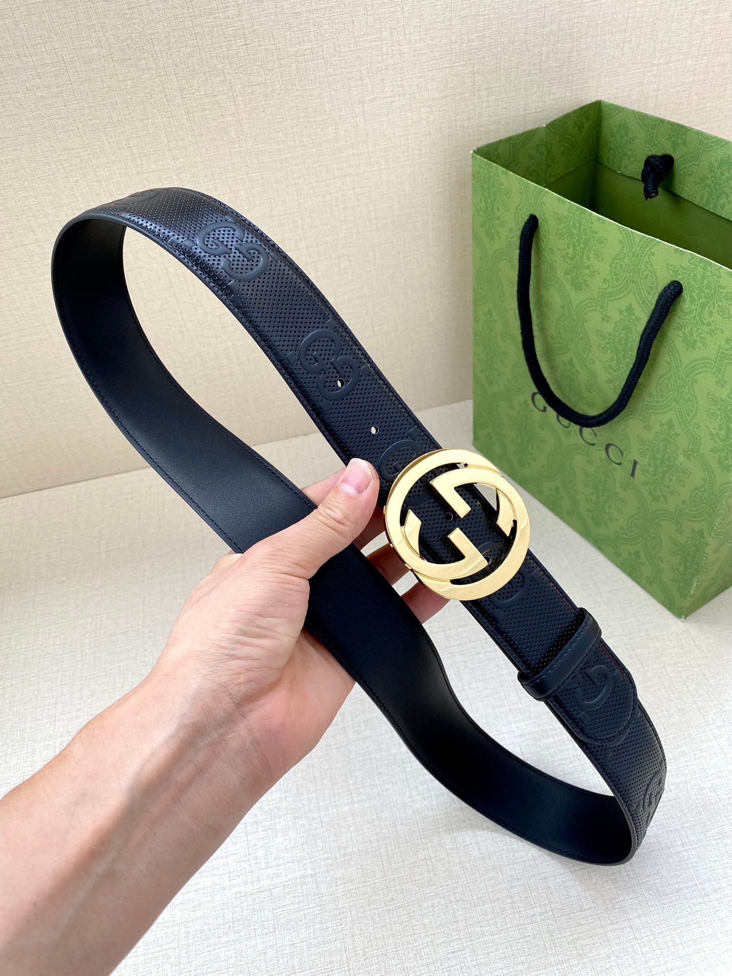 Navy leather belt with silver-toned GG logo circular buckle